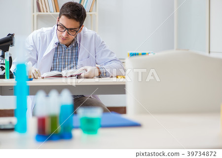 Young chemist student working in lab on chemicals 39734872