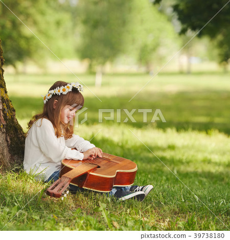 boy and girl playing guitar in summer park boy and girl playing guitar in summer park 39738180