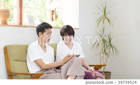 Smiling couple looking at a tablet Smiling couple looking at a tablet 39739524