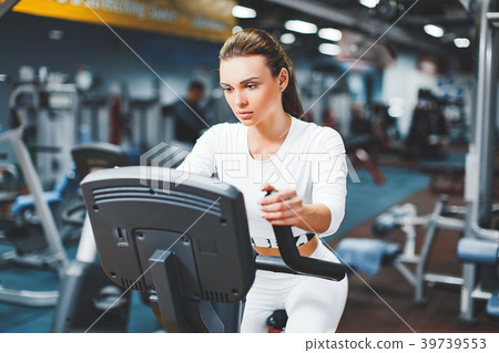 Indoor cycling woman doing cardio workout biking 39739553
