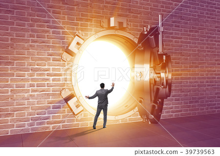 Businessman in front of banking vault door 39739563