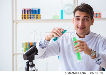 Young chemist student working in lab on chemicals Young chemist student working in lab on chemicals 39740191