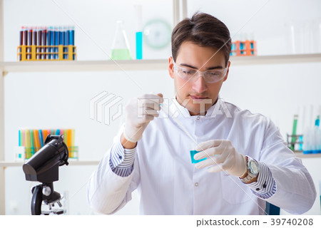 Young chemist student working in lab on chemicals Young chemist student working in lab on chemicals 39740208