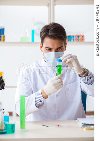 Young chemist student working in lab on chemicals Young chemist student working in lab on chemicals 39740241
