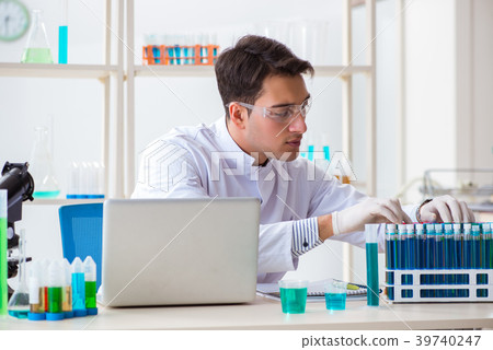 Man student working in chemical lab on experiment Man student working in chemical lab on experiment 39740247