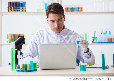 Man student working in chemical lab on experiment Man student working in chemical lab on experiment 39740415