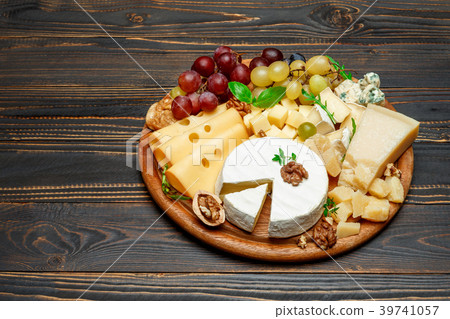 various types of cheese on wooden cutting board various types of cheese on wooden cutting board 39741057