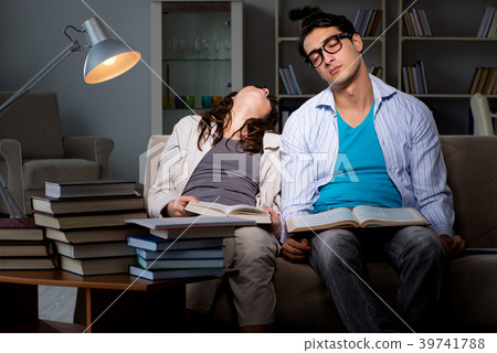 Two students studying late preparing for exams Two students studying late preparing for exams 39741788