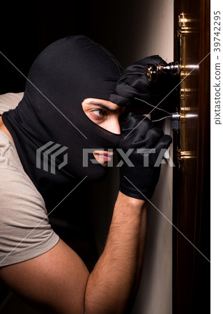 Burglar wearing balaclava mask at crime scene 39742295