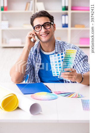 Young designer working on new project and choosing Young designer working on new project and choosing 39742411