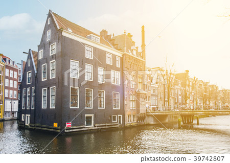 Traditional old building facade in Amsterdam along Traditional old building facade in Amsterdam along 39742807