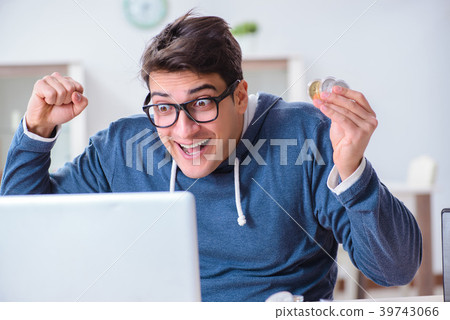 Young man mining bitcoins at home 39743066