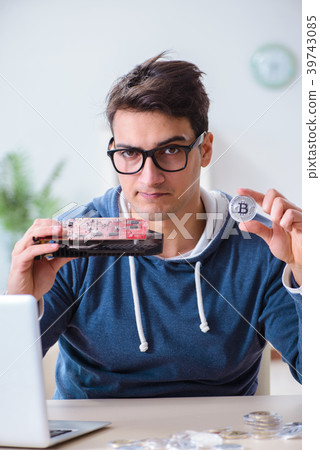 Young man mining bitcoins at home 39743085