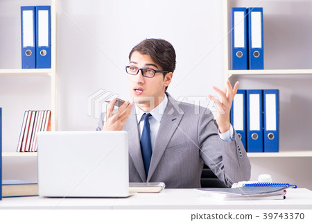 Businessman employee talking on the office phone 39743370