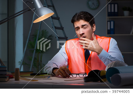 Construction architect working on drawings late at 39744005