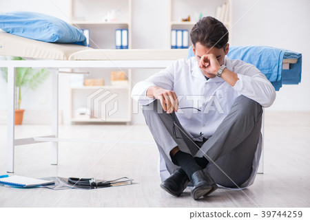 Doctor sitting on the floor in hospital 39744259