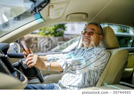 Elderly man driving with car 39744493