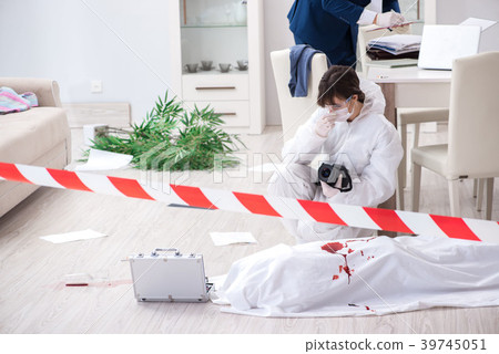 Forensics investigator at the scene of office Forensics investigator at the scene of office 39745051