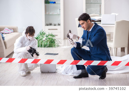 Forensics investigator at the scene of office 39745102