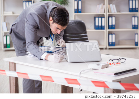 Forensics investigator at the scene of office 39745255