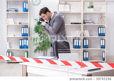 Forensics investigator at the scene of office 39745298
