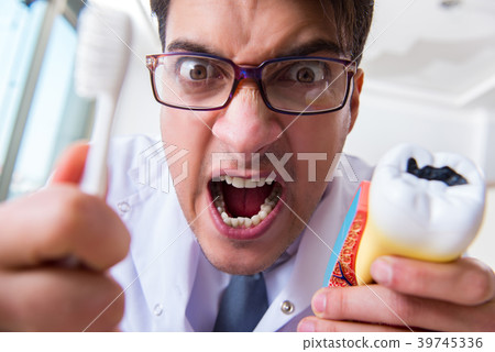 Funny dentist with toothbrush in medical concept 39745336
