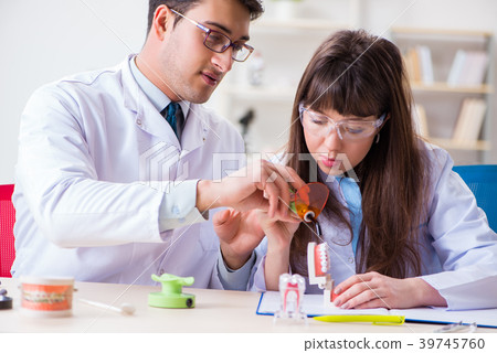 Doctor explaining to assistant how to use 39745760