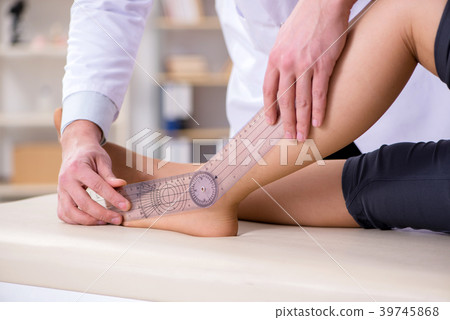 Doctor checking patients joint flexibility 39745868