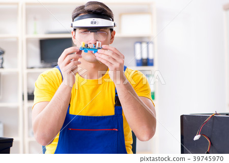 Computer repair technician repairing hardware 39745970