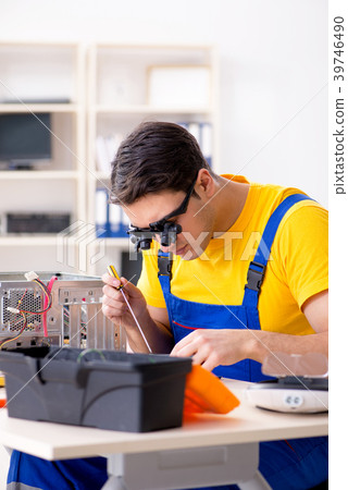 Computer repair technician repairing hardware 39746490