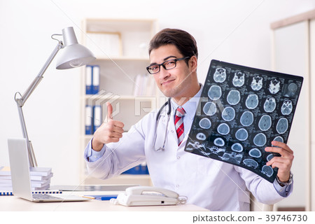 Young handsome doctor working in hospital room Young handsome doctor working in hospital room 39746730