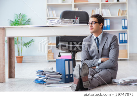 Businessman working and sitting on floor in office 39747075