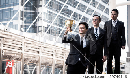Happy Asian business people with golden trophy cup 39749148