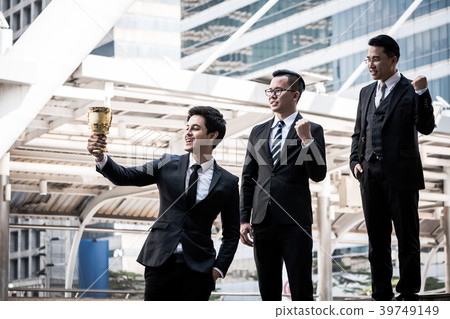 Happy Asian business people with golden trophy cup 39749149
