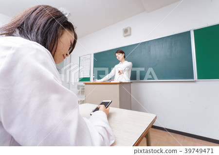 Teacher who is careful with student using smartphone during class 39749471