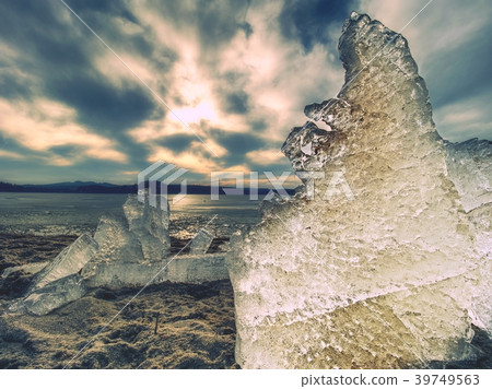 Ice melting on sandy beach.  Detail of ice floe 39749563