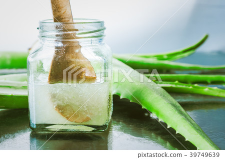 Fresh aloe vera and jelly in glass bottle Fresh aloe vera and jelly in glass bottle 39749639