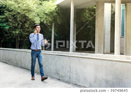 Young Businessman Talk via Smartphone while walk Young Businessman Talk via Smartphone while walk 39749645