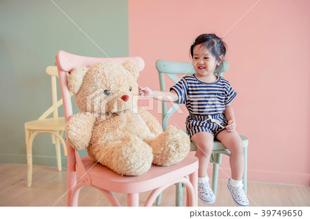 A Two Years Old Child Sitting with her Teddy Bear. A Two Years Old Child Sitting with her Teddy Bear. 39749650