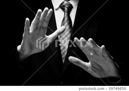 Close up of man in black suit with hand gesture  39749850