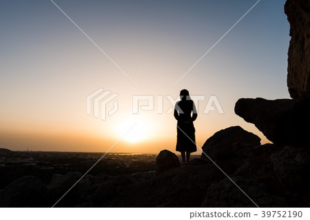 Female hiker on the mountain top facing the sunset 39752190
