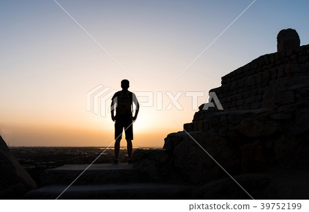 Male hiker on the mountain top silhouette shot 39752199