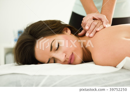 Young woman receiving a back massage in a spa center. 39752250