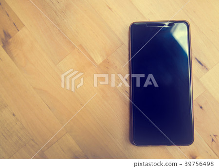 Smart phone on wooden table background  39756498