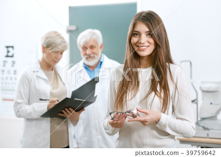 Pretty patient staying in front of old oculist and 39759642