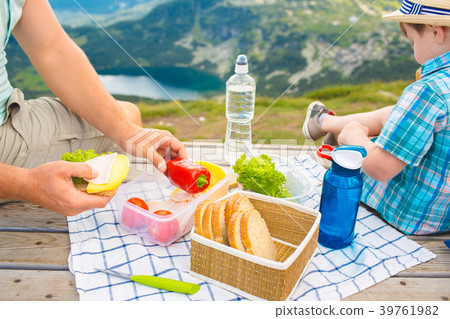 Family on a picnic in the mountains Family on a picnic in the mountains 39761982