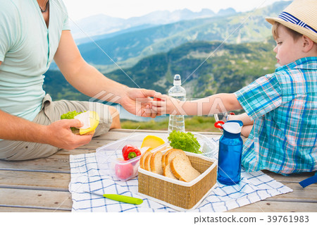 Family on a picnic in the mountains Family on a picnic in the mountains 39761983