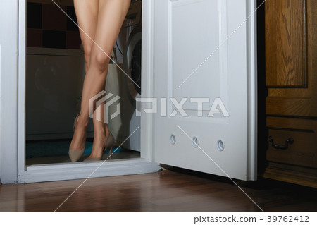 Bare female legs in doorway of the bathroom 39762412