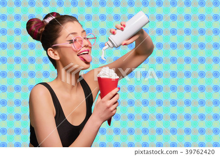 Young fancy model pressing cream into red horn. 39762420