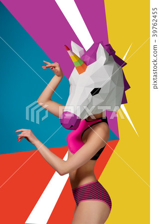 Slim model wearing colorful unicorn's head. 39762455